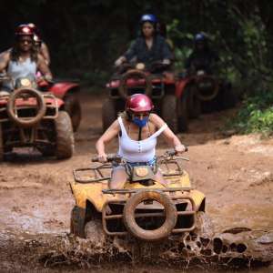 young woman feeling adventure tours in cancun driving ATV in the mod