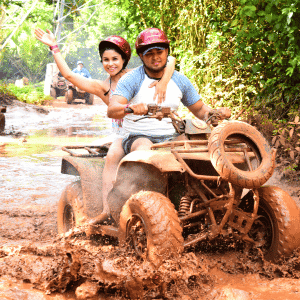 young couple driving atv in cancun adventure